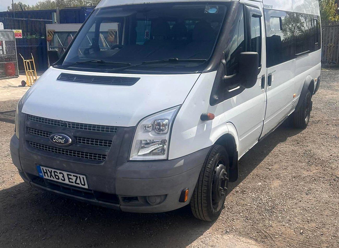 A white Compare Minibus Travel minibus, one of the 5 to 7 seat options