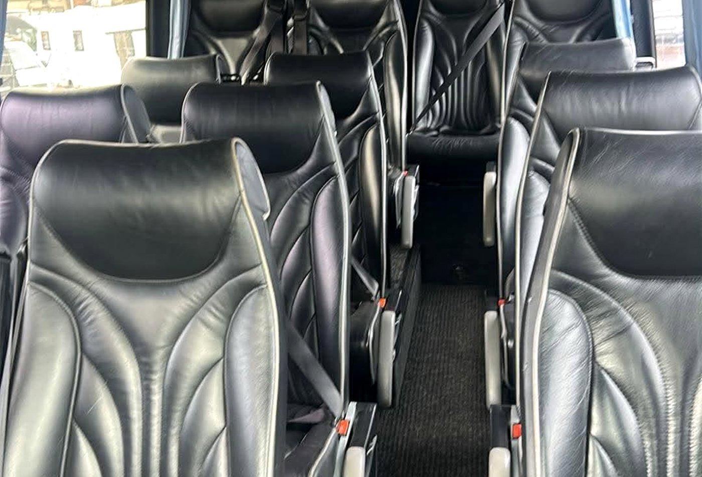 Black leather executive seating inside a Compare Minibus Travel minibus