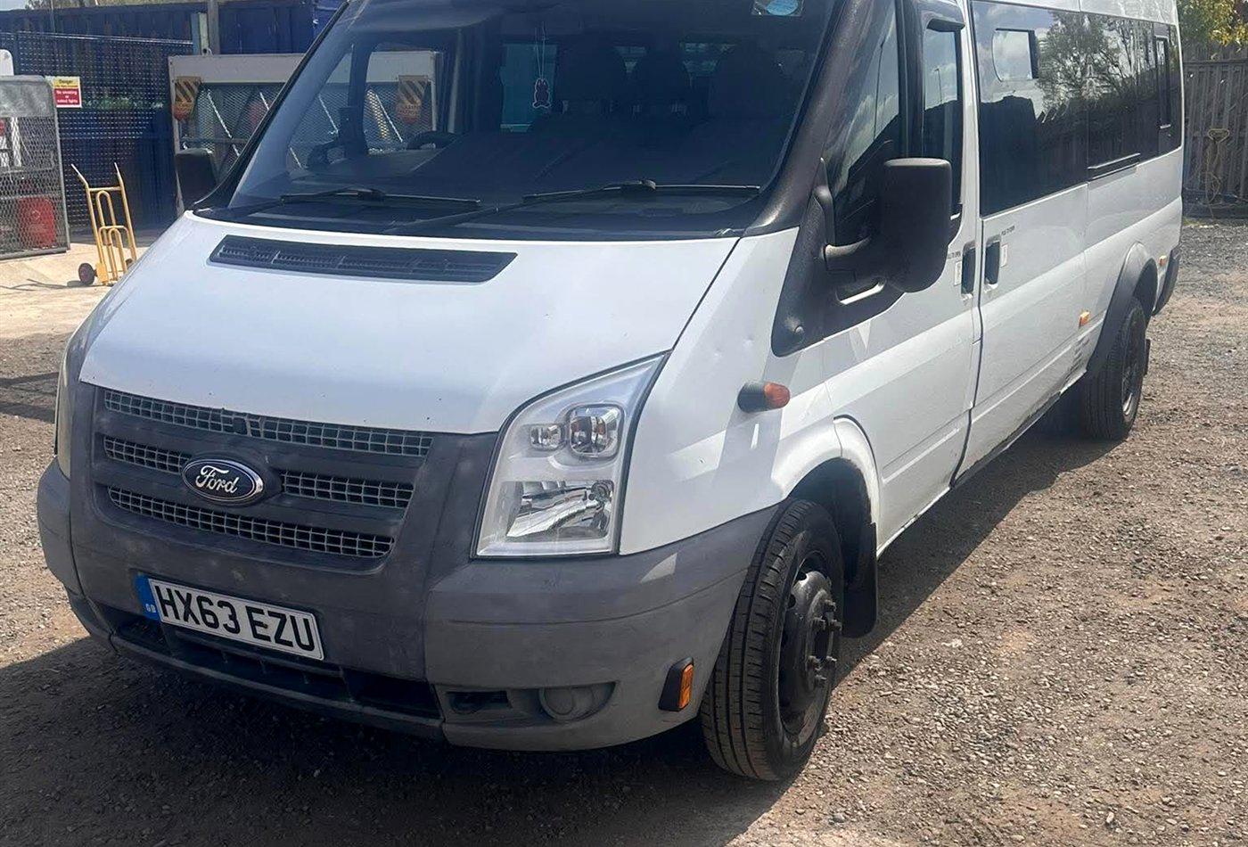 A white Compare Minibus Travel minibus used for school transport