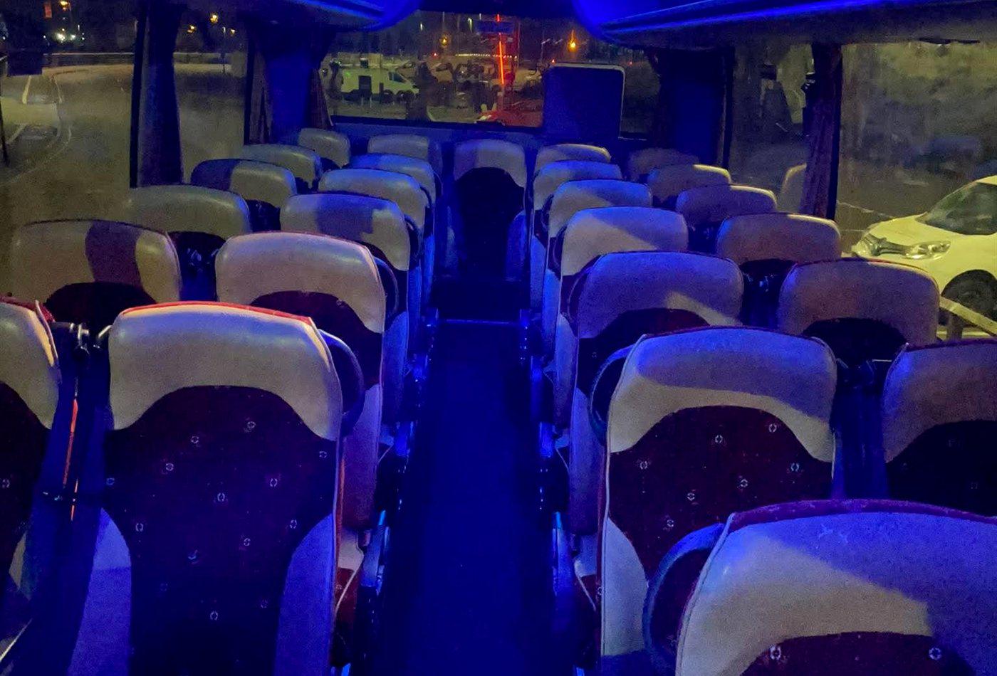 Interior of a Compare Minibus Travel coach lit with blue mood lighting
